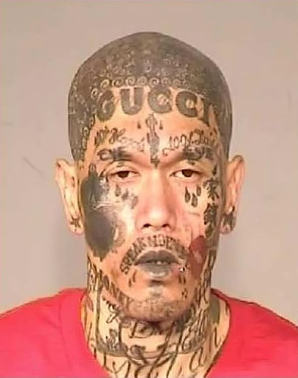 Fresno felon Khamprasong Thammavong, tattooed head to chin with 'speak no evil,' was arrested with tactical gear and guns